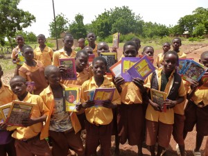 Excited children receiving their books and pencils in 2014